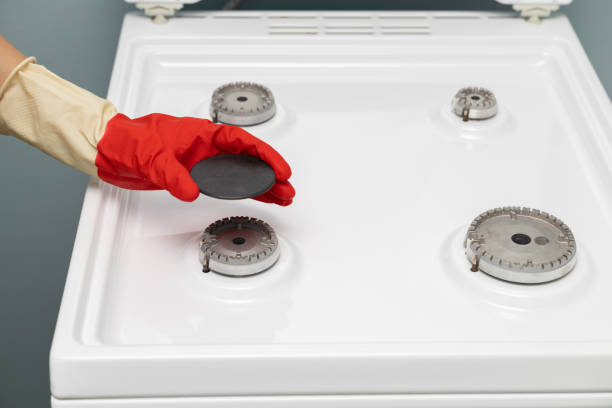 man washing a gas stove with a rag. assembling gas burner