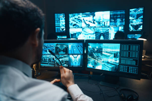 Police officers at surveillance control center wide