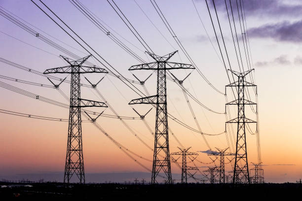 Electricity pylons during dusk evening sky sunset